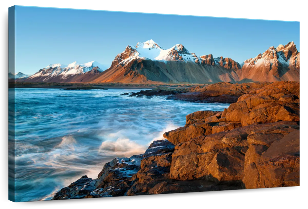 Crashing Waves Snowcapped Mountains